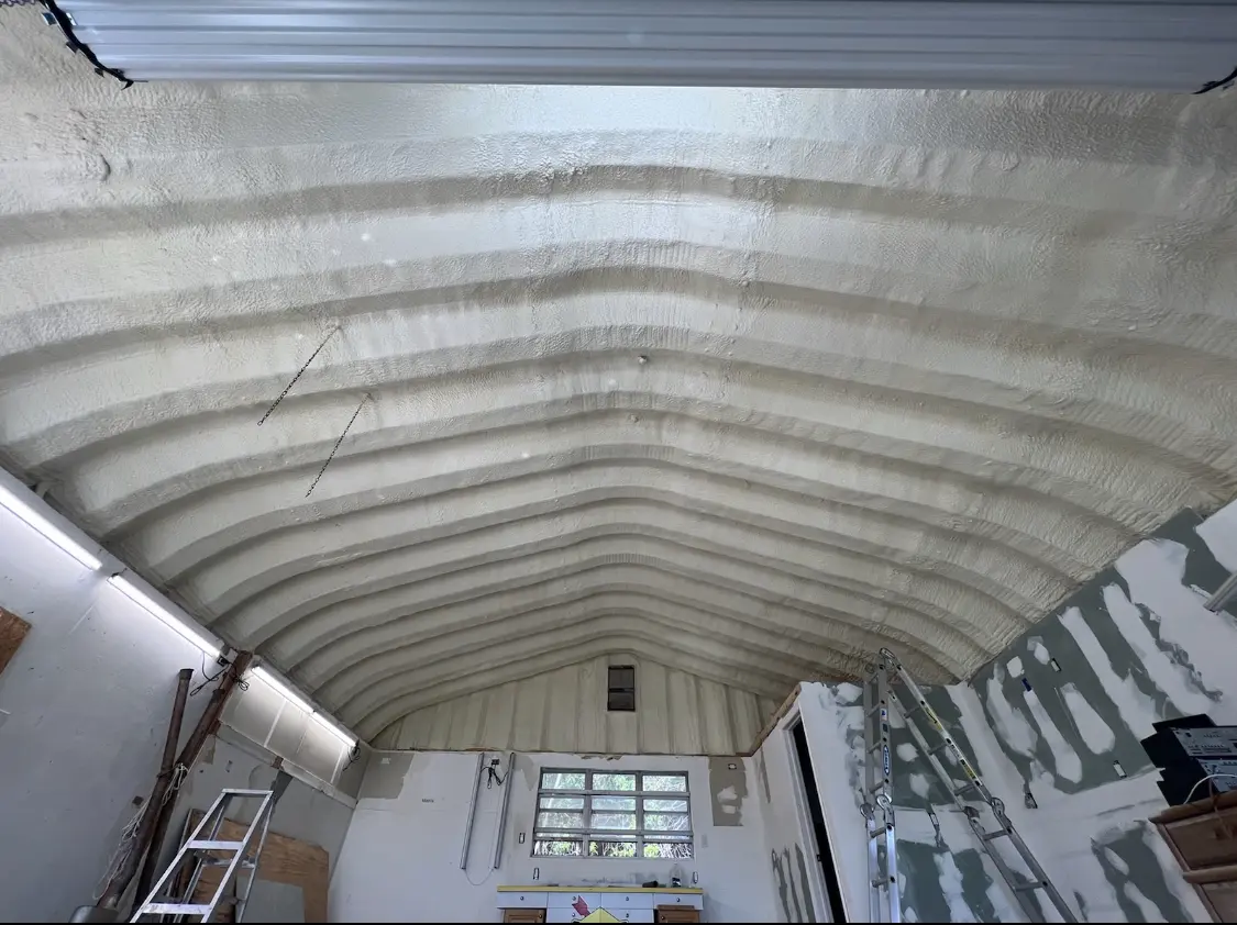 Spray polyurethane foam applied to the underside of a metal roof deck in Burke